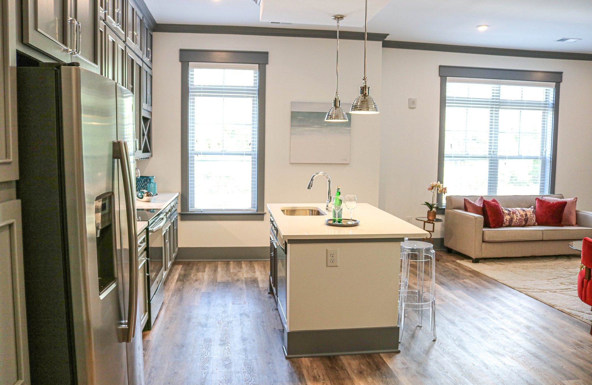 interior of apartment showing kitchen area with kitchen island and bright windows