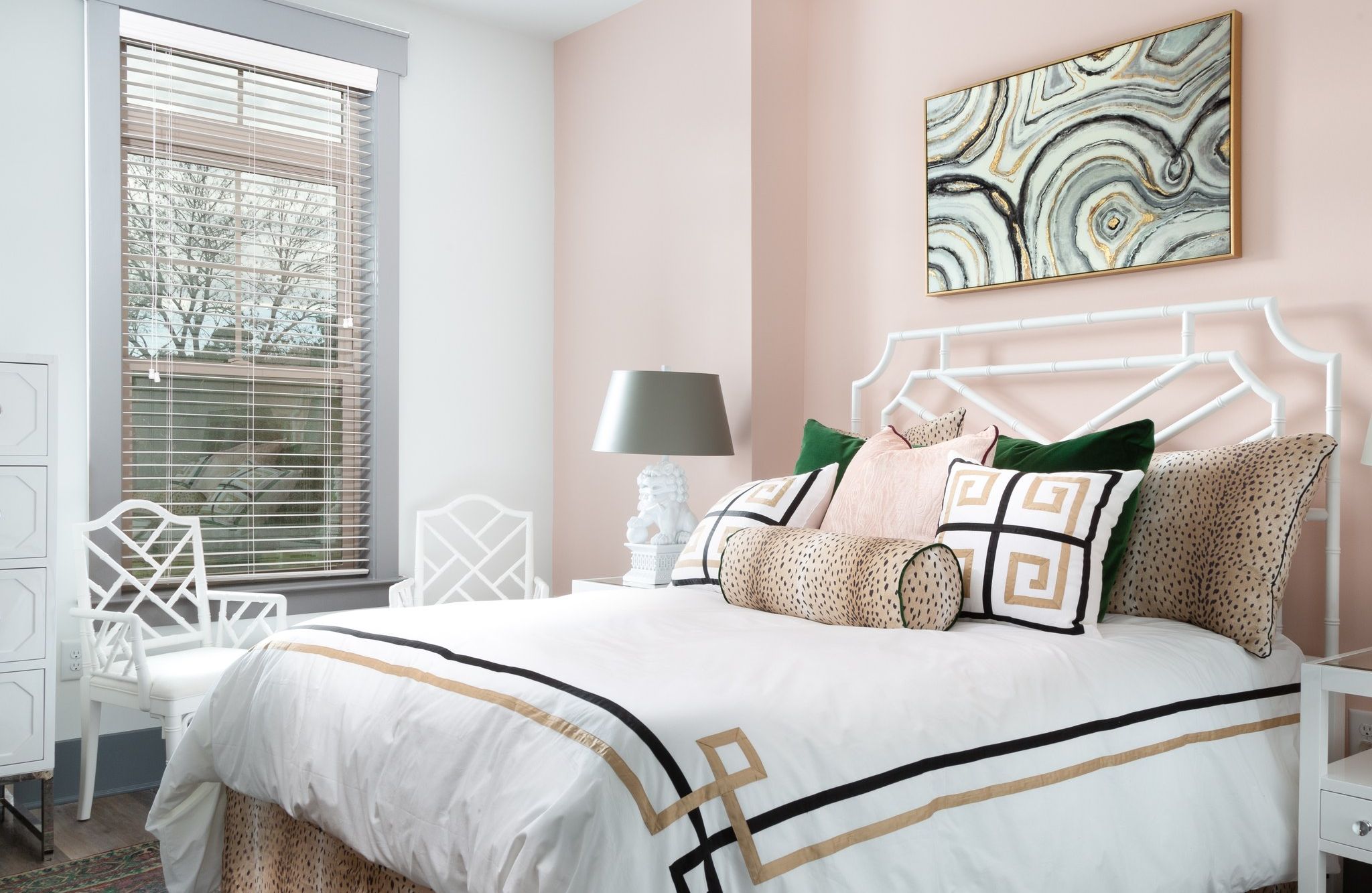 bedroom inside apartment with comfy bed, natural light, and accent wall