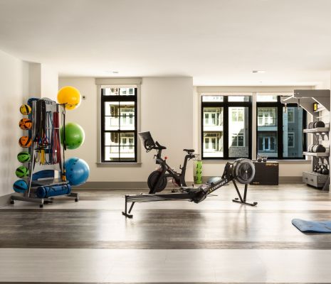 Concept 2 rower and other exercise equipment inside two-story gym