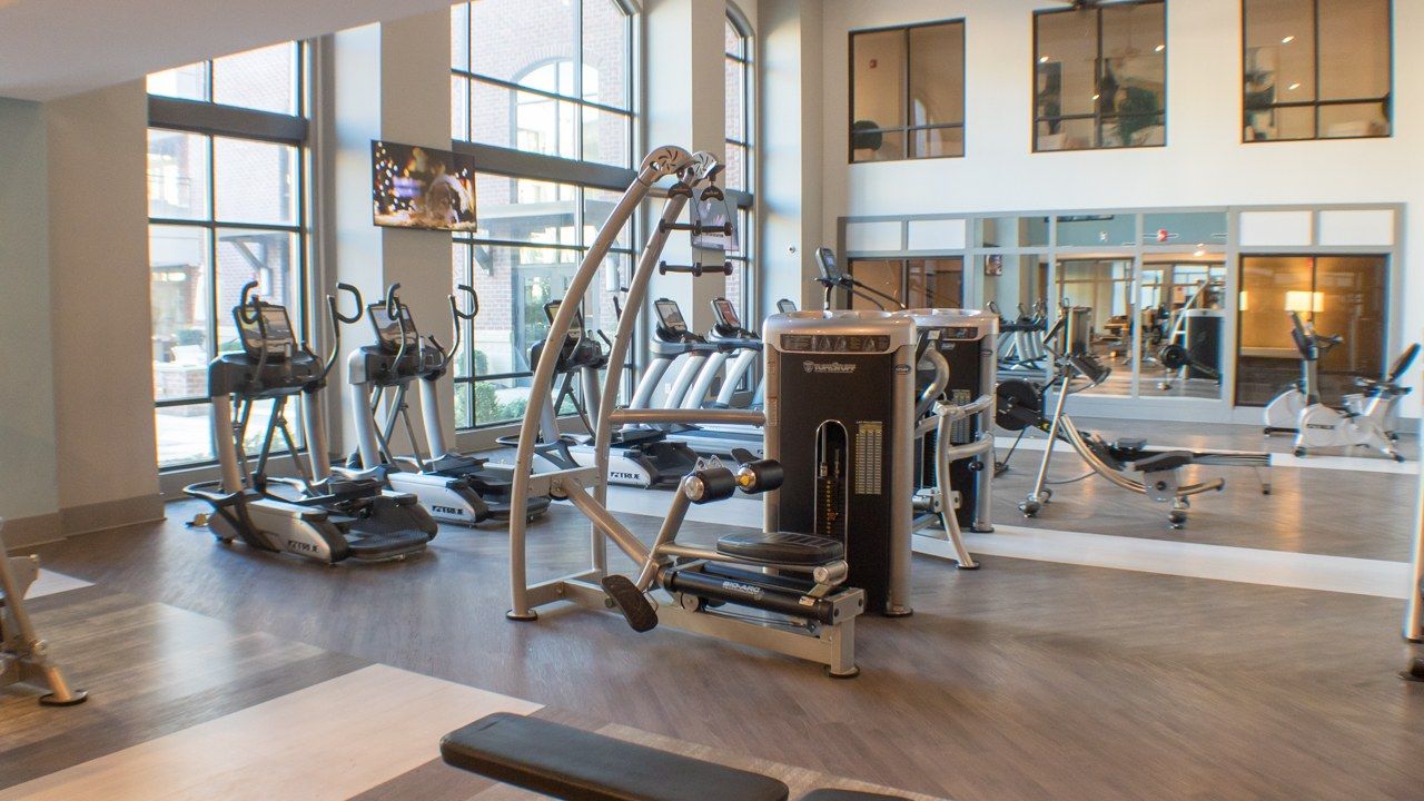 Fitness equipment inside Providence Row Apartments' large gym and fitness space for residents