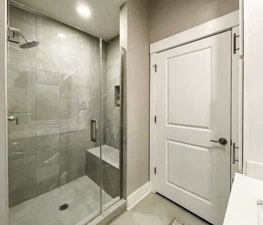 frameless glass shower with tile in luxury apartment bathroom