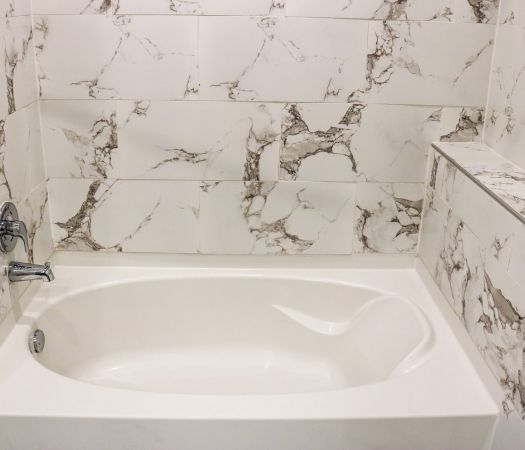 Roman soaking tub with tile surround at Providence Row luxury apartment