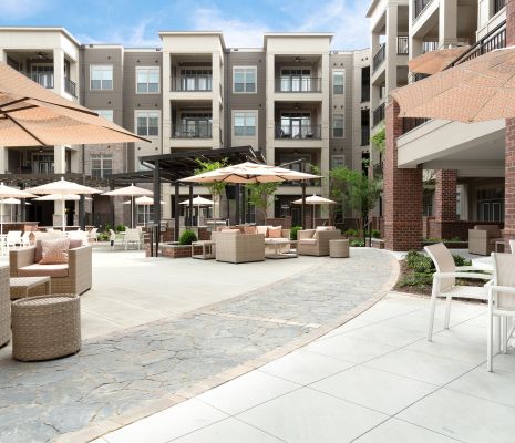 Outdoor patio with umbrellas, fireplaces, and seating