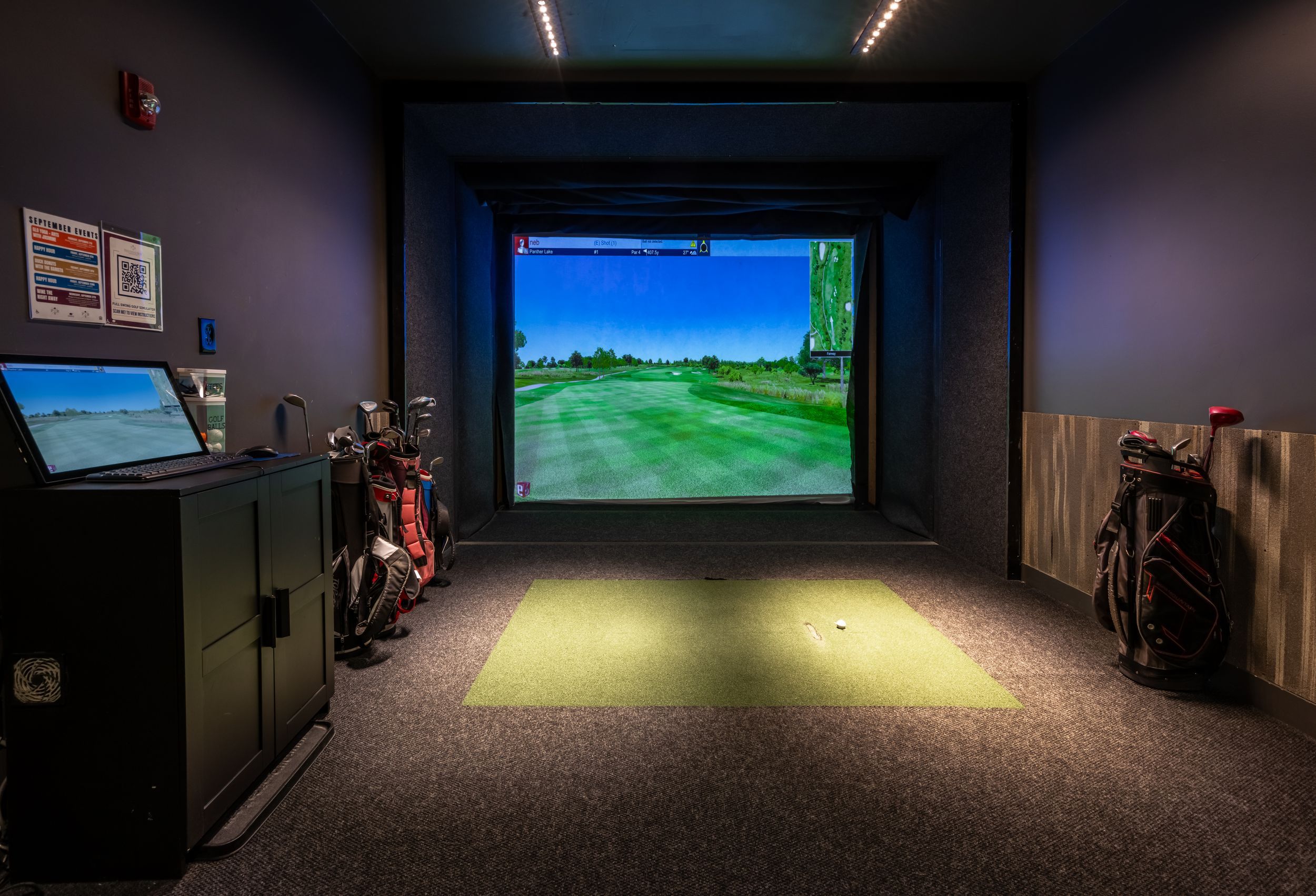 Golf simulator with bag of golf clubs