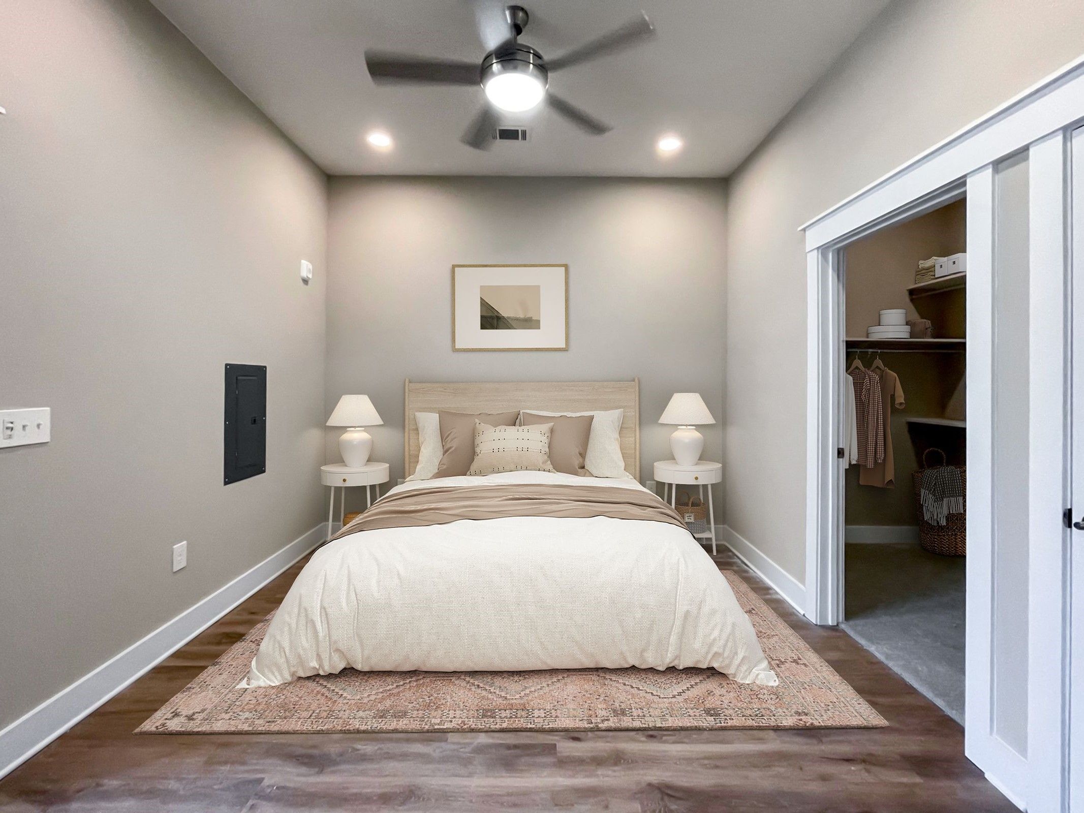 Large apartment bedroom with vinyl plank flooring and king sized bed at Providence Row