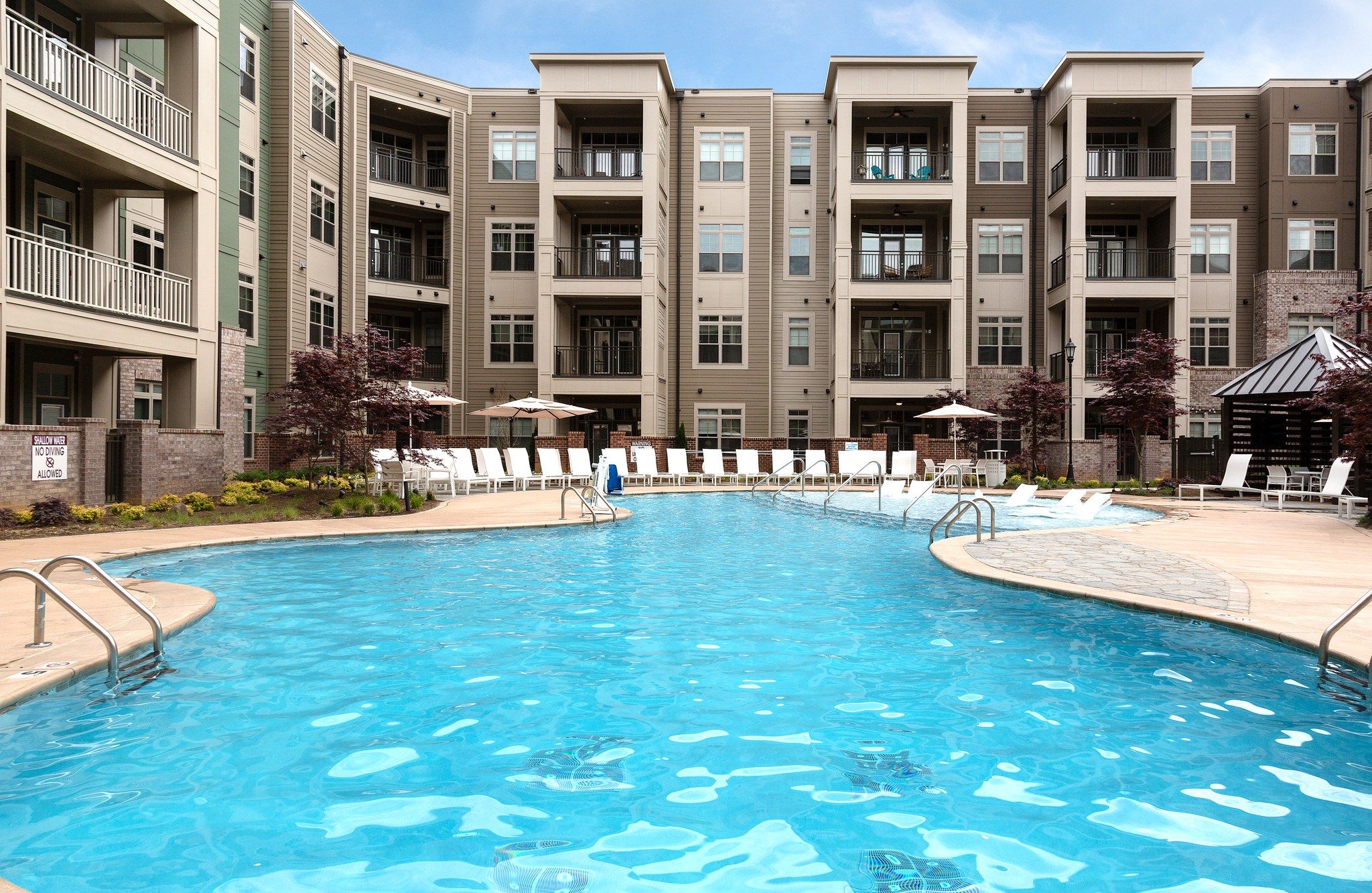 Luxury pool with blue water outside of Providence Row Apartments