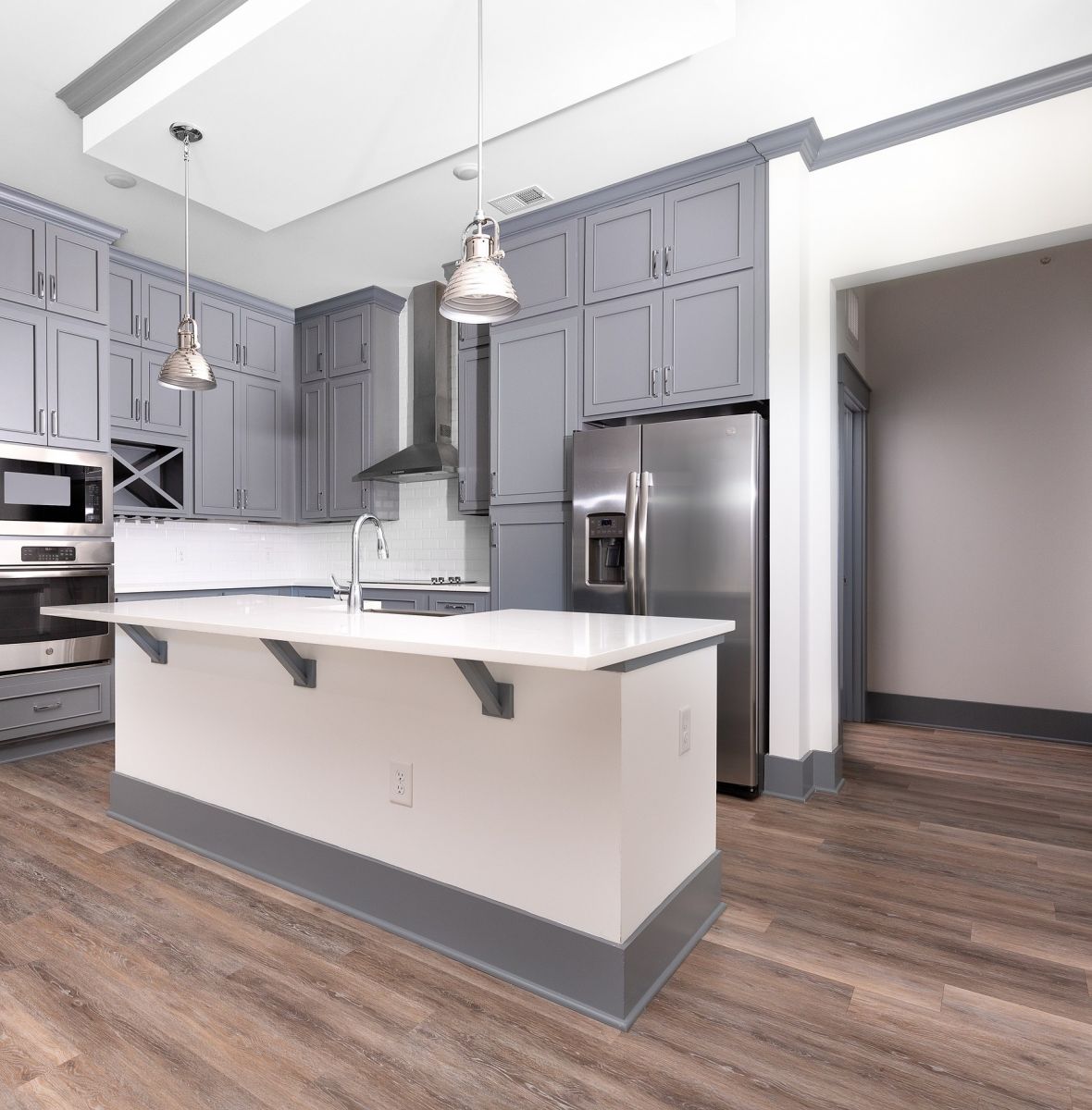Providence Row apartment kitchen with island, stainless steel appliances, and beautiful finishes