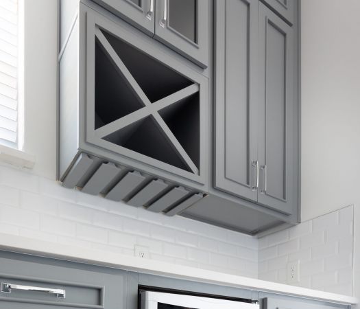 Built-in wine storage next to apartment kitchen cabinetry