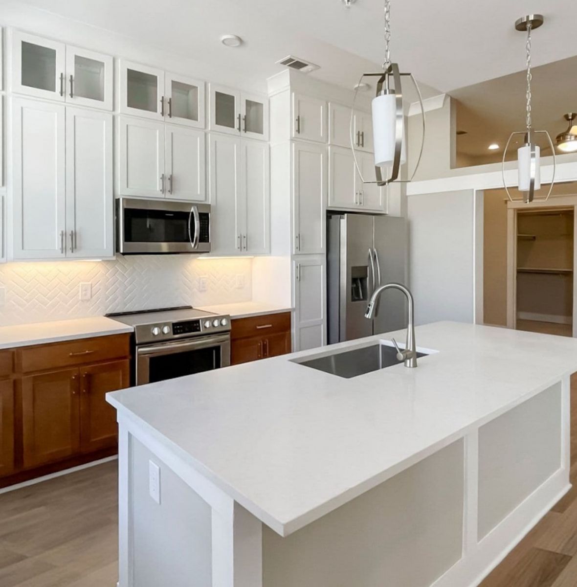 Providence Row apartment kitchen with island, stainless steel appliances, and beautiful finishes